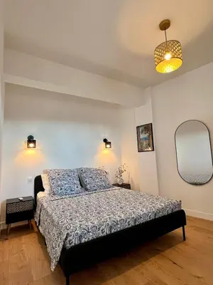 a bedroom with a bed and a mirror at TheNiceTerrace in Nice
