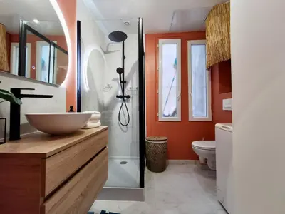 a bathroom with a sink and a shower and a toilet at Cosy Savoie by Bookking Guys in Nice