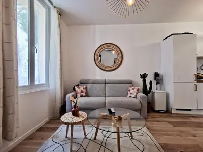 a living room with a couch and a table at Cosy Savoie by Bookking Guys in Nice