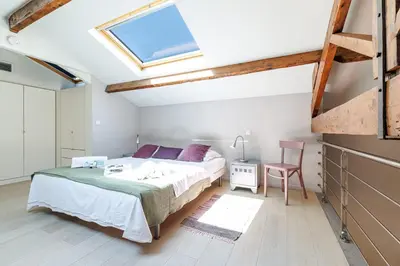 a bedroom with a bed and a skylight at MY CASA - FRANCE 82 - 2 rooms -1 min from the Sea - Parking in Nice