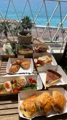 a table with a bunch of different types of food at 2 Pièce - Promenade des Anglais in Nice