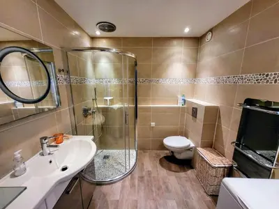 a bathroom with a shower and a toilet and a sink at Ferber Garden - Appartement de charme avec deck privé in Nice