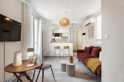 a living room with a couch and a table at Nice Renting - 35b MASSENA - Chic Cosy Calm Balcony Massena Pedestrian Heart in Nice