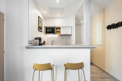 a kitchen with two chairs and a counter at Nice Renting - 35b MASSENA - Chic Cosy Calm Balcony Massena Pedestrian Heart in Nice