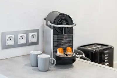 a coffee maker with two cups on a counter at Nice Renting - 35b MASSENA - Chic Cosy Calm Balcony Massena Pedestrian Heart in Nice