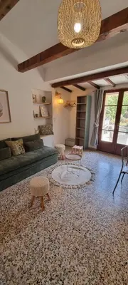 a living room with a couch and a table and chairs at Le Jas in Tourrette-Levens