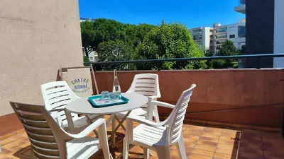 a white table and chairs on a balcony at Studio La Madrague Côte d'Azur in Cros-de-Cagnes