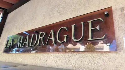 a metal sign on the side of a building at Studio La Madrague Côte d'Azur in Cros-de-Cagnes