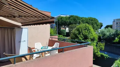 a balcony with chairs and a table on a balcony at Studio La Madrague Côte d'Azur in Cros-de-Cagnes