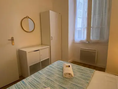 a bedroom with a bed with a towel on it at Studio Smile FSHH in Nice