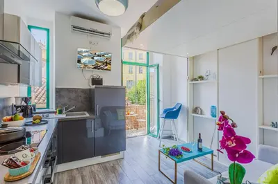 a kitchen with white walls and a large window at MY CASA - CASSINI - Garibaldi Square - AC in Nice