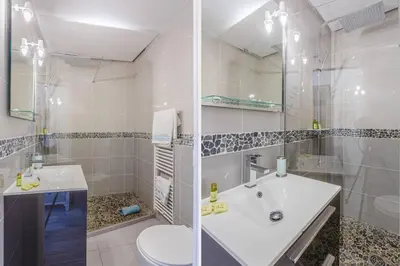 a white bathroom with a sink and a toilet at MY CASA - CASSINI - Garibaldi Square - AC in Nice