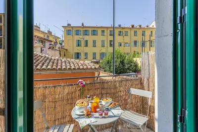 a table with food and drinks on a balcony at MY CASA - CASSINI - Garibaldi Square - AC in Nice