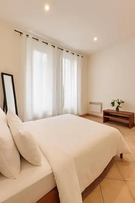 a large white bedroom with a large white bed at Charming & roomy apartment with balcony heart of Nice in Nice