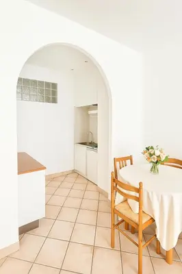 a kitchen and dining room with a table and chairs at Charming & roomy apartment with balcony heart of Nice in Nice