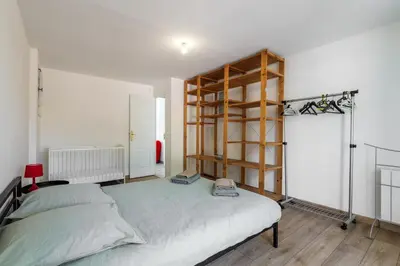a bedroom with a bed and a book shelf at Villa les Oliviers in La Gaude