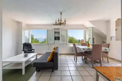 a living room with a couch and a table at Villa les Oliviers in La Gaude