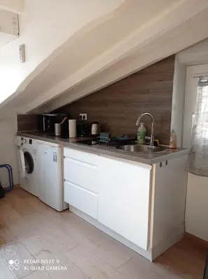 a kitchen with a sink and a washing machine at Studio dernier étage vieux Nice centre in Nice