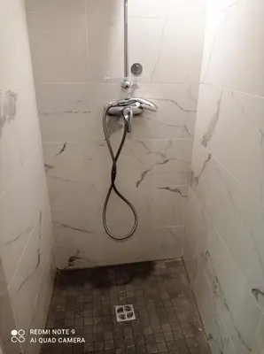 a shower with a hose in a bathroom at Studio dernier étage vieux Nice centre in Nice