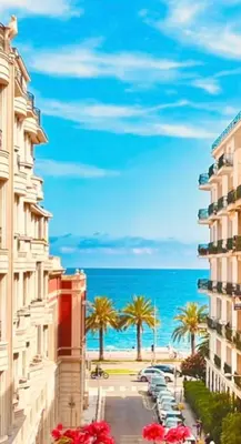 two palm trees and people riding bikes on the beach at Sweet Suite Nice in Nice