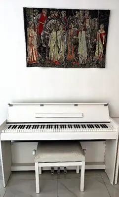 a white piano in a room with a painting on the wall at Sweet Suite Nice in Nice