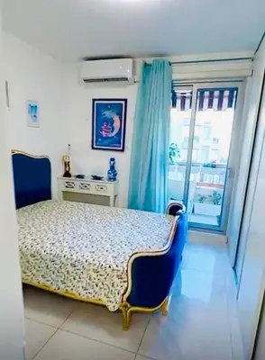 a bedroom with a bed with a blue bed frame and a window at Sweet Suite Nice in Nice