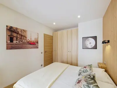a bedroom with a bed and a picture on the wall at Nestor&Jeeves - MAYA TERRASSE - Centre ville in Nice