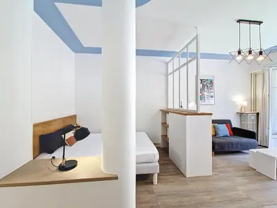 a white room with a bed and a couch at Nestor&Jeeves - ESPRIT SUD - Near Promenade des Anglais in Nice