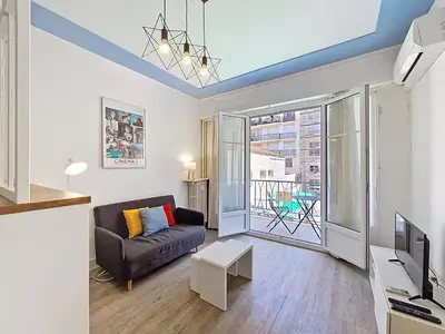 a living room with a couch and a tv at Nestor&Jeeves - ESPRIT SUD - Near Promenade des Anglais in Nice