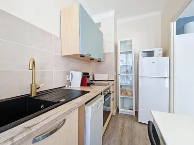 a kitchen with a sink and a white refrigerator at Nestor&Jeeves - ESPRIT SUD - Near Promenade des Anglais in Nice