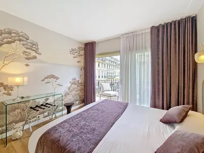 a bedroom with a large bed and a window at Nestor&Jeeves - VICTORIA - Delux apartment city center in Nice