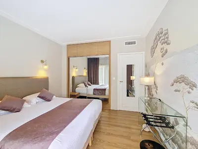 a hotel room with a large bed and a mirror at Nestor&Jeeves - VICTORIA - Delux apartment city center in Nice