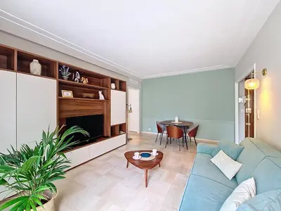 a living room with a blue couch and a table at Nestor&Jeeves - VICTORIA - Delux apartment city center in Nice