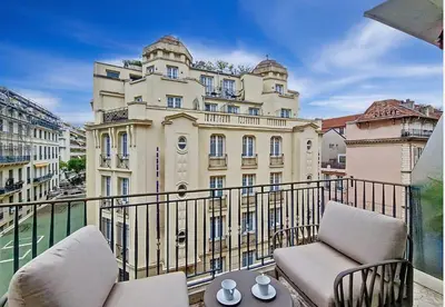 a balcony with two chairs and a building at Nestor&Jeeves - VICTORIA - Delux apartment city center in Nice