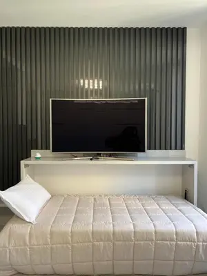 a bedroom with a bed with a flat screen tv at Grand Studio Luxe in Nice