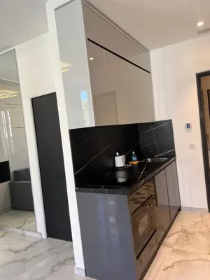 a kitchen with a black counter top in a room at Grand Studio Luxe in Nice