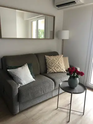 a living room with a couch and a table at Le Clio Hyper Centre proche Promenade in Nice