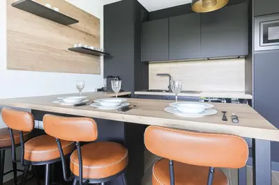 a kitchen with a large counter with stools at Ciel d'Azur - Climatisé piscine partagée in Saint-Laurent-du-Var