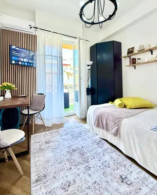 a bedroom with a bed with two yellow pillows at Studio in the center balcony AC in Nice