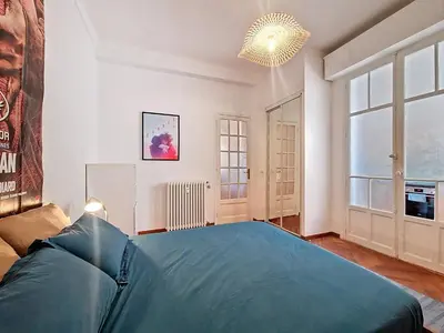 a bedroom with a large bed and a large window at Nestor&Jeeves - PALAIS DE LA SIRENE - Near Promenade des Anglais in Nice