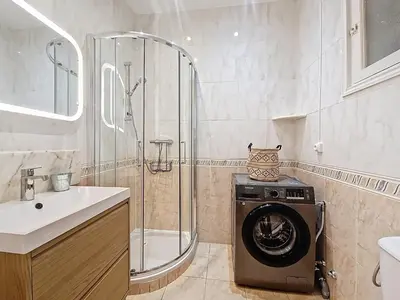 a bathroom with a shower and a washing machine at Nestor&Jeeves - PALAIS DE LA SIRENE - Near Promenade des Anglais in Nice