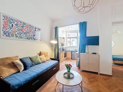 a living room with a blue couch and a table at Nestor&Jeeves - PALAIS DE LA SIRENE - Near Promenade des Anglais in Nice