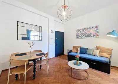 a living room with a couch and a table at Nestor&Jeeves - PALAIS DE LA SIRENE - Near Promenade des Anglais in Nice