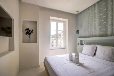 a bedroom with a white bed with a window at Grand appartement Centre de Nice in Nice