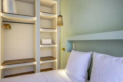 a bedroom with a bed with white pillows at Grand appartement Centre de Nice in Nice
