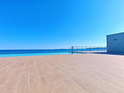 a view of a pier with the ocean in the background at SEA SIDE - Rooftop Pool SeaView in Saint-Laurent-du-Var