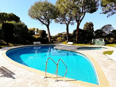 a swimming pool with trees in the background at Blue dream and zen Holidays in Nice