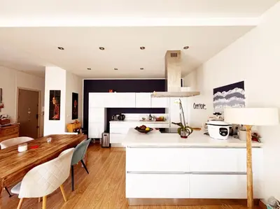 a kitchen with white cabinets and a table and chairs at Blue dream and zen Holidays in Nice