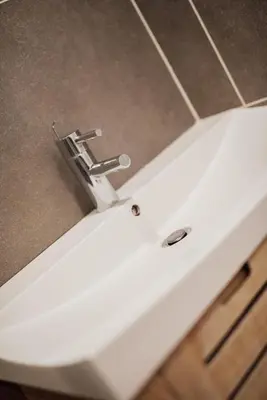 a white sink with a faucet on top of a counter at Le Chic, appartement plein centre avec Climatisation in Nice