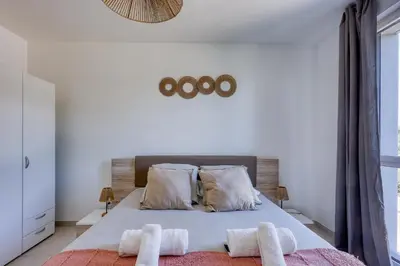 a bedroom with a bed with two towels on it at Chez Valentina et Alexandre Port et plages à pied in Saint-Laurent-du-Var